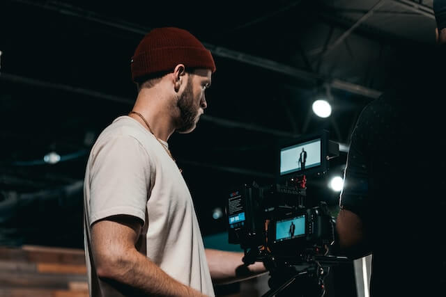 men overlooking camera